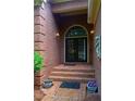 Elegant brick entryway with an arched doorway, brick steps, and decorative flower pots at 1187 Ward Creek Sw Dr, Marietta, GA 30064