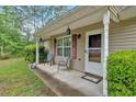 Charming front porch with seating and classic details, enhancing the home's curb appeal at 161 Gann Cemetery Rd, Dallas, GA 30157