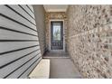 A charming front entrance features a gray door with brick accents, enhancing curb appeal at 1610 Habersham Villa Dr, Cumming, GA 30041