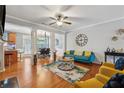 Bright living room with hardwood floors, a ceiling fan, and access to the dining area, offering a comfortable living space at 3040 Clear View Ln, Snellville, GA 30078