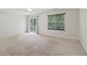 Spacious bedroom with neutral carpet, window and sliding glass door with outdoor views at 755 Magnolia Gardens Walk, Mcdonough, GA 30253