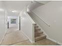 Open hallway with carpeted stairs and neutral walls leading to additional rooms at 755 Magnolia Gardens Walk, Mcdonough, GA 30253
