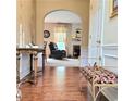 Inviting entryway with hardwood floors leading to a cozy sitting area and fireplace at 3703 Liberty Sw Dr, Powder Springs, GA 30127