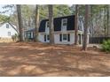 Quaint two-story home with mature trees and attached garage at 7020 Camp Valley Rd, Riverdale, GA 30296