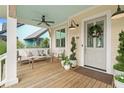 Relaxing front porch with stylish seating, wooden floors, and a view of the neighborhood at 11190 Serenbe Ln, Chattahoochee Hills, GA 30268