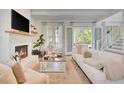 Bright living room featuring a cozy fireplace and French doors to the outside at 11190 Serenbe Ln, Chattahoochee Hills, GA 30268