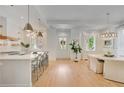 Open-concept living space features a modern kitchen and dining area with ample natural light at 11190 Serenbe Ln, Chattahoochee Hills, GA 30268