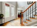 Bright foyer featuring hardwood floors, a staircase with iron spindles, and a glass-paneled front door at 3389 Robinson Farms Ne Trce, Marietta, GA 30068