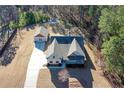 Aerial view of a gray house with a long driveway and a detached two-car garage at 510 Boulder View Parkway, Dallas, GA 30157