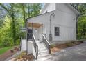 Charming two-story home with white siding, dark railings, and a inviting front entry at 1080 Westmont Sw Rd, Atlanta, GA 30311