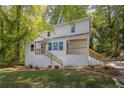 Charming two-story home with a welcoming front porch and a freshly painted exterior at 1080 Westmont Sw Rd, Atlanta, GA 30311