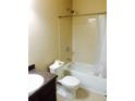Functional bathroom with a tiled shower-tub combo, vanity with sink, and standard toilet at 476 Elm Nw St, Atlanta, GA 30318