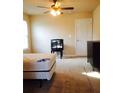 A cozy bedroom with neutral carpet and ceiling fan offers a relaxing retreat at 476 Elm Nw St, Atlanta, GA 30318
