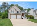 Charming two-story home featuring a two-car garage, stone accents, and a welcoming front lawn at 5975 Tate Dr, Austell, GA 30106
