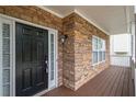 Close-up of the front door showcasing stone accents, covered porch, and a modern black door at 5975 Tate Dr, Austell, GA 30106