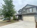The home's facade boasts a two-car garage, coordinating shutters, manicured landscaping, and a neatly kept lawn at 2166 Villa Spring Ct, Dacula, GA 30019