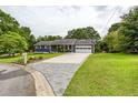 Inviting home with a long driveway leading to an attached garage and a beautifully landscaped front yard at 4812 Pamela Nw Ct, Acworth, GA 30101