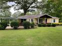 Well-maintained, charming yellow home with attached carport on a large, grassy lot at 5760 Brenda Sw Dr, Mableton, GA 30126