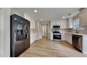 Modern kitchen with stainless steel appliances, ample white cabinetry, and light countertops at 8256 Milam Loop, Fairburn, GA 30213