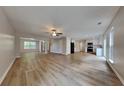 Expansive living area showcasing light flooring, ceiling fan, and seamless flow to kitchen at 8256 Milam Loop, Fairburn, GA 30213