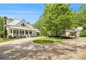A beautiful, sprawling home with a circular driveway and lush landscaping creating an inviting outdoor space at 8901 Watkins Mill Rd, Winston, GA 30187