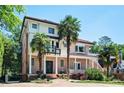 Elegant two-story home showcases palm trees, a tile roof, brick accents, and a welcoming front entry at 1216 E Rock Springs Ne Rd, Atlanta, GA 30306