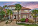 Striking two-story home with mature landscaping and a sunset sky, adding warmth and charm at 1216 E Rock Springs Ne Rd, Atlanta, GA 30306