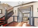 Inviting foyer featuring dark trim, hardwood floors, a staircase, and an open doorway at 1216 E Rock Springs Ne Rd, Atlanta, GA 30306