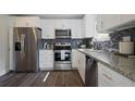 A newly renovated kitchen with stainless steel appliances and stone countertops at 2222 Hill Nw St, Atlanta, GA 30318