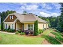 Well-maintained single-Gathering home with lush landscaping and inviting curb appeal at 608 Red Leaf Way, Canton, GA 30114