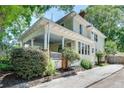 Charming two-story home featuring a welcoming front porch with a driveway on the side at 1157 Alta Ne Ave, Atlanta, GA 30307