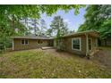 Cozy single-story home with neutral siding and a secluded, tree-lined backyard at 1304 Anchor Sw Ter, Atlanta, GA 30311
