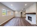 Bright living room featuring wood floors, recessed lighting, and a cozy fireplace at 1304 Anchor Sw Ter, Atlanta, GA 30311