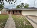 Well-kept single-story brick home featuring arched entryway and attached garage at 25 Stonehedge Dr, Buford, GA 30518