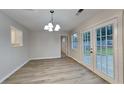 Bright dining area featuring new floors, patio access, and modern chandelier lighting at 943 Colvin Dr, Locust Grove, GA 30248