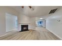 Cozy living room with modern floors and a classic fireplace at 943 Colvin Dr, Locust Grove, GA 30248