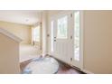 Bright foyer featuring a decorative front door with glass panels and hardwood flooring with a decorative rug at 1130 Laurel Cove Dr, Snellville, GA 30078
