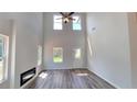 Spacious living room featuring vaulted ceilings, modern fireplace and wood floors, filled with natural light at 2 Loth Wages (Lot 2) Rd, Dacula, GA 30019