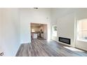 Bright living room featuring high ceilings, wood floors, and a modern fireplace open to the kitchen at 2 Loth Wages (Lot 2) Rd, Dacula, GA 30019