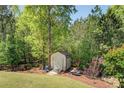 Well-maintained backyard features a storage shed with table and chairs for outdoor enjoyment at 345 Piedmont Cir, Covington, GA 30016