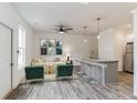 Bright living room open to kitchen and featuring stylish flooring and modern ceiling fan at 4011 Redan Rd # 7, Stone Mountain, GA 30083