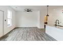 Bright living room open to kitchen and featuring stylish flooring and modern ceiling fan at 4011 Redan Rd # 7, Stone Mountain, GA 30083
