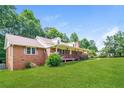 Side view of single-story brick house with covered front porch and large yard at 263 Austin Rd, Stockbridge, GA 30281