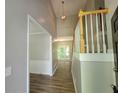 Inviting entryway with wood-look floors, a staircase, and a view into the living room at 3838 Glenlake Springs Nw Ct, Kennesaw, GA 30144