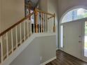 Bright entryway featuring wood-look floors, staircase with white trim, and arched doorway at 3838 Glenlake Springs Nw Ct, Kennesaw, GA 30144