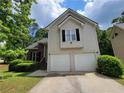Two-story house with vinyl siding, brick accents, a two-car garage, and a well-maintained lawn at 3838 Glenlake Springs Nw Ct, Kennesaw, GA 30144