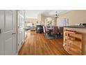 Open-concept dining and living area features hardwood floors, neutral paint, a fireplace, and a staircase at 59 Townview Dr, Alpharetta, GA 30022