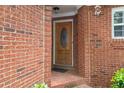 Inviting brick entryway featuring a charming front door with brick columns and a traditional design at 59 Townview Dr, Alpharetta, GA 30022