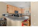 Functional kitchen with sleek countertops, light wood cabinets, and modern black appliances at 59 Townview Dr, Alpharetta, GA 30022