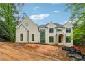 View of the house featuring a neutral color palette and eye-catching black-trim windows at 388 Londonberry Road, Sandy Springs, GA 30327